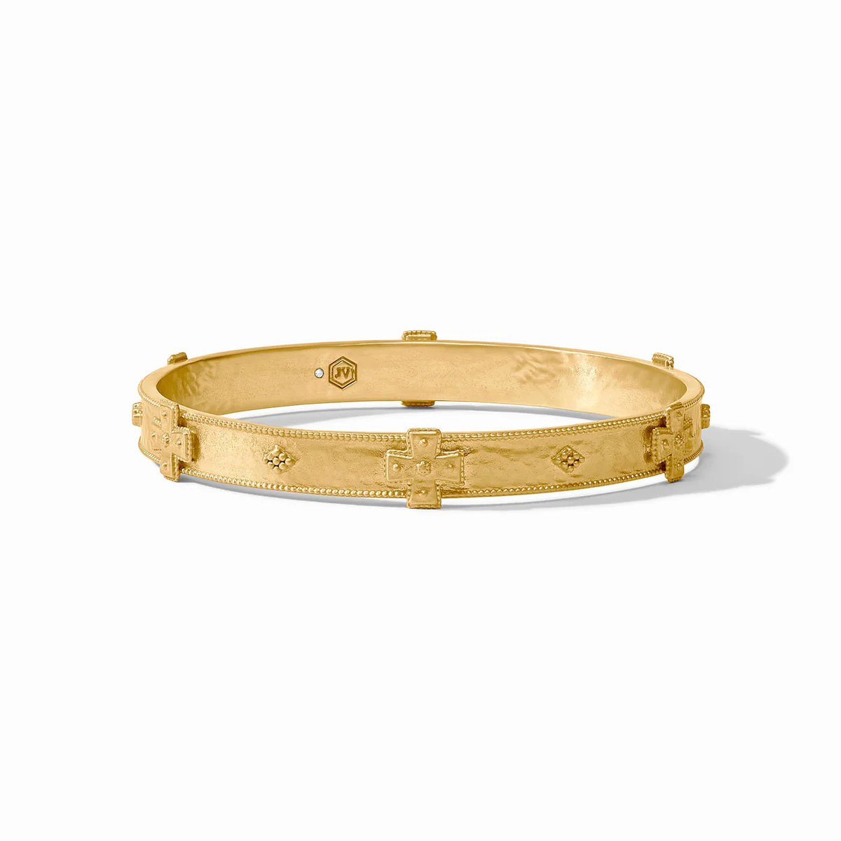 Gold-tone bangle with repeating cross pattern, smooth interior, hinged closure
