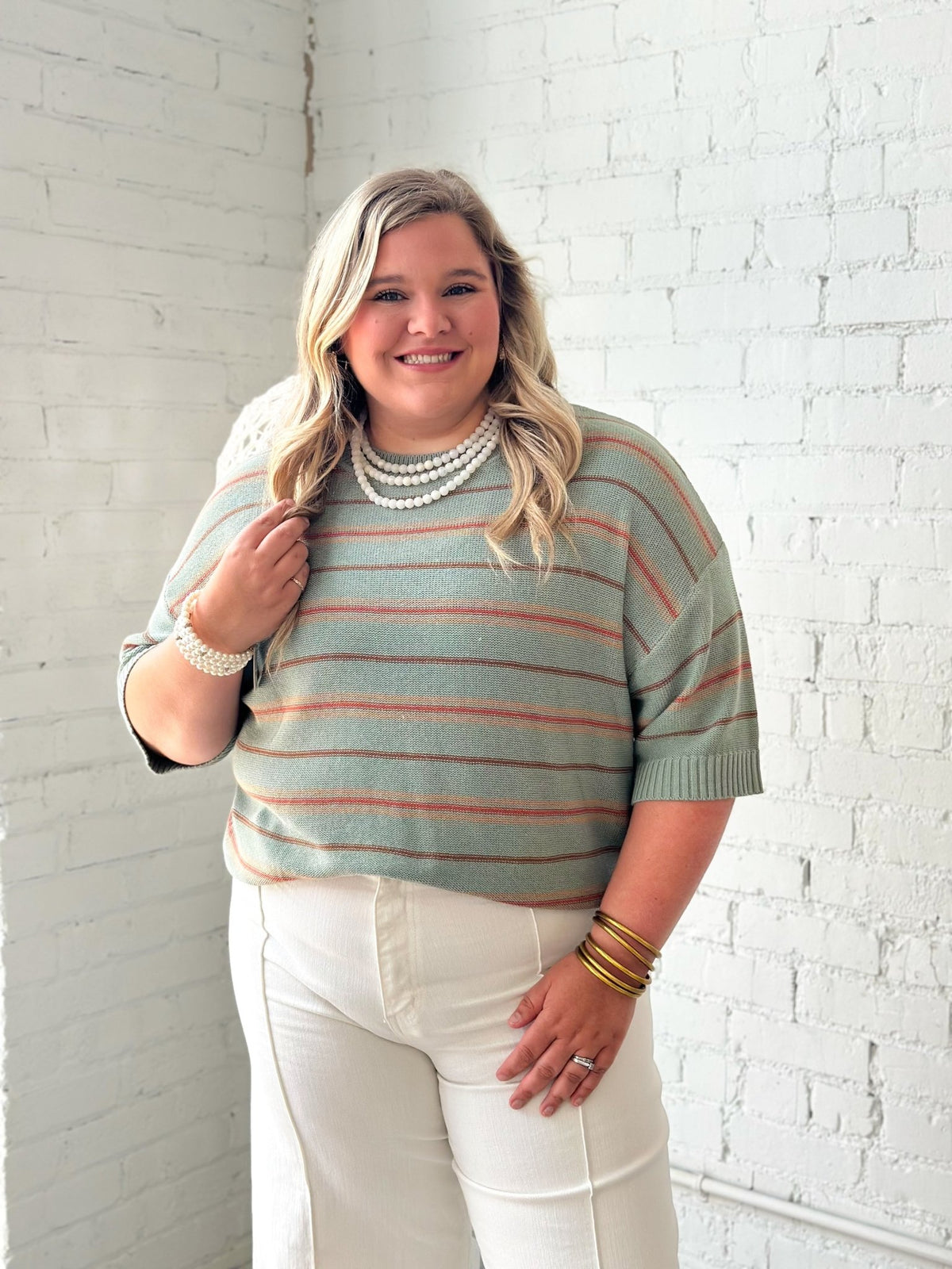Sage sweater with horizontal stripes and a relaxed body