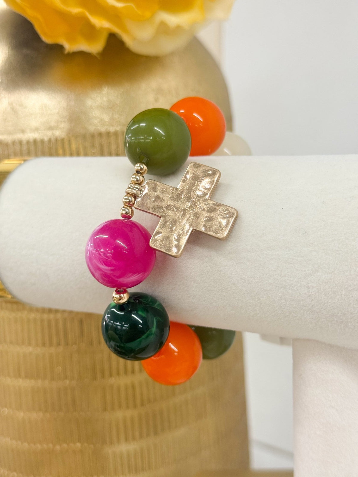 Beaded stretch bracelet with a hanging gold cross