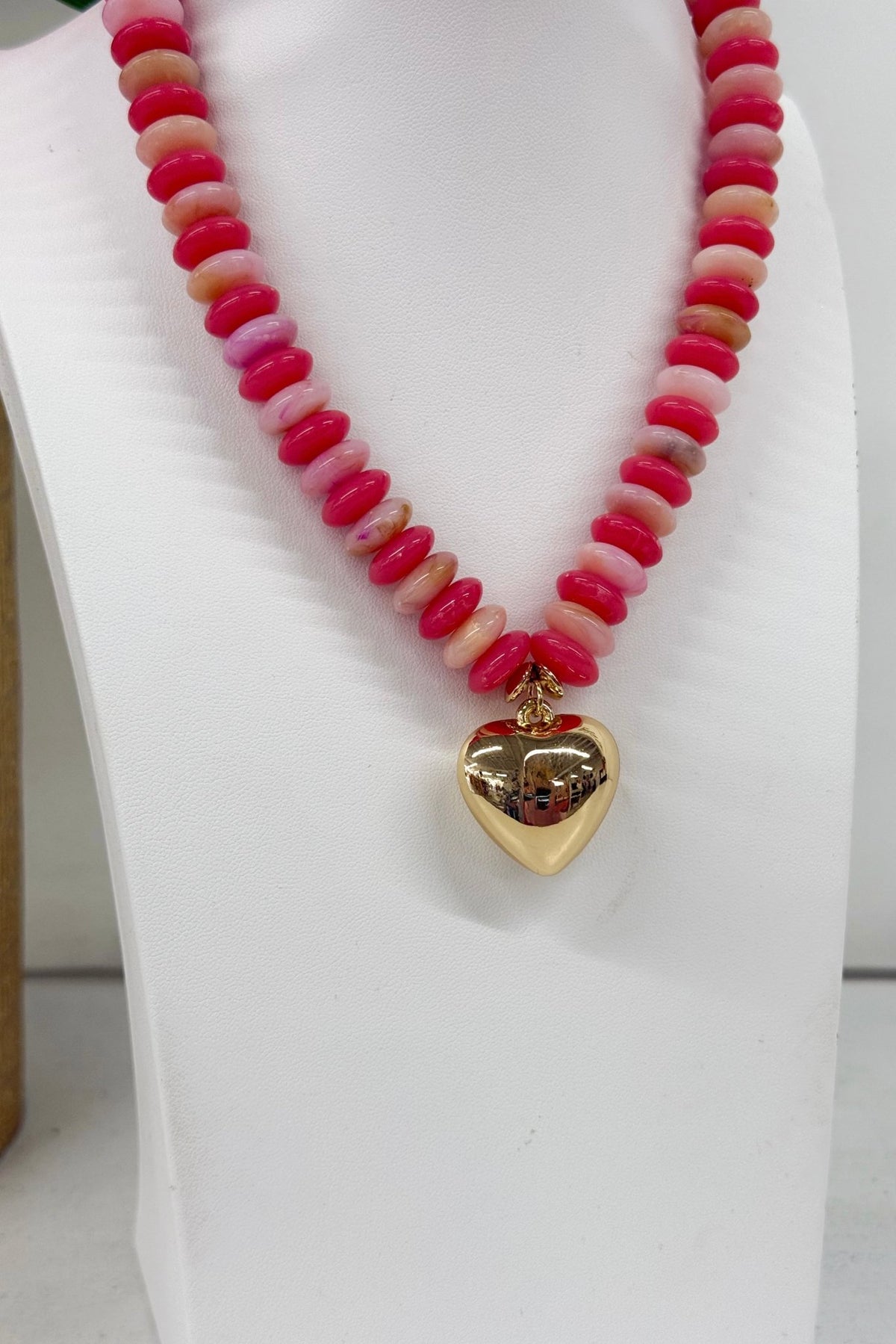 Coral bead strand with a hanging heart pendant