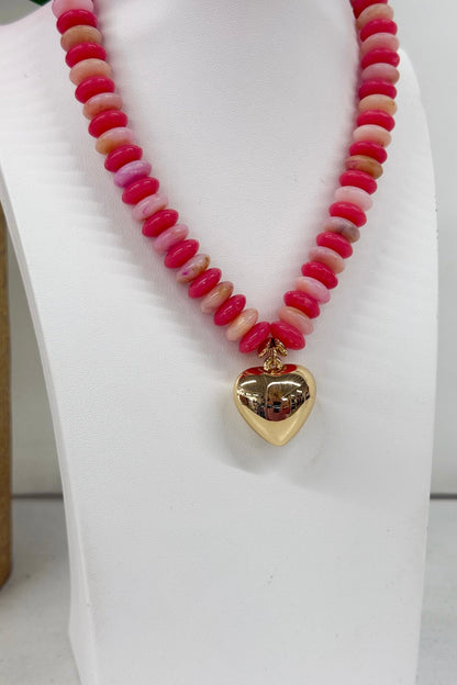 Coral bead strand with a hanging heart pendant