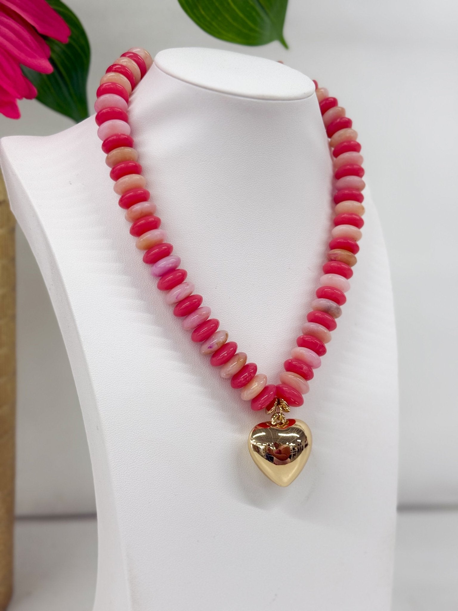Gold heart pendant on a coral bead necklace