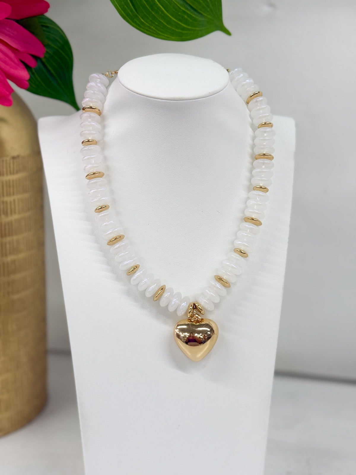Pale opal beads strung with a heart pendant
