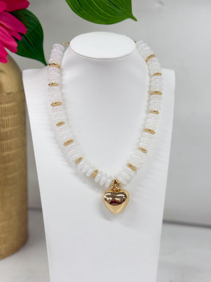 Pale opal beads strung with a heart pendant