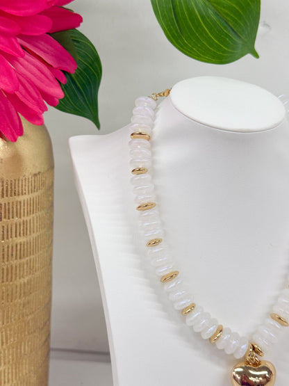 Gold heart charm on an opal white bead strand