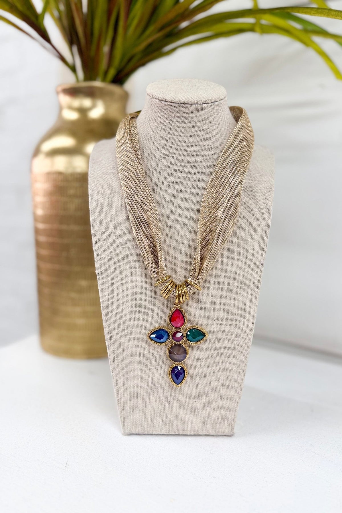 Gold cross pendant necklace on a fine chain
