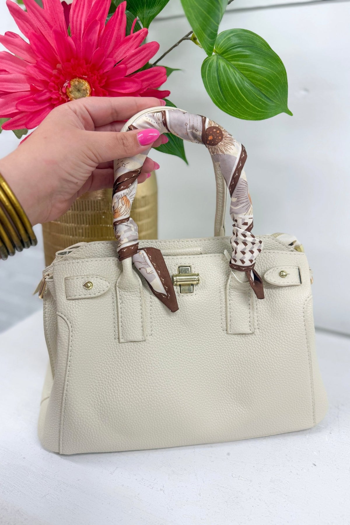 Beige handbag with a scarf-wrapped top handle