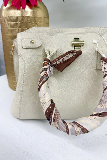 Beige satchel bag with silk scarf detail on the handle