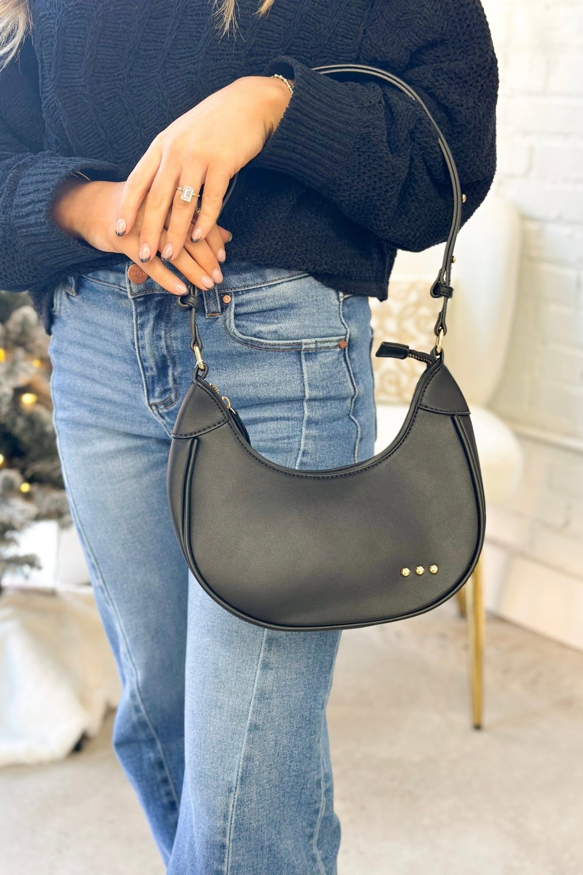 Black crescent-shaped shoulder bag