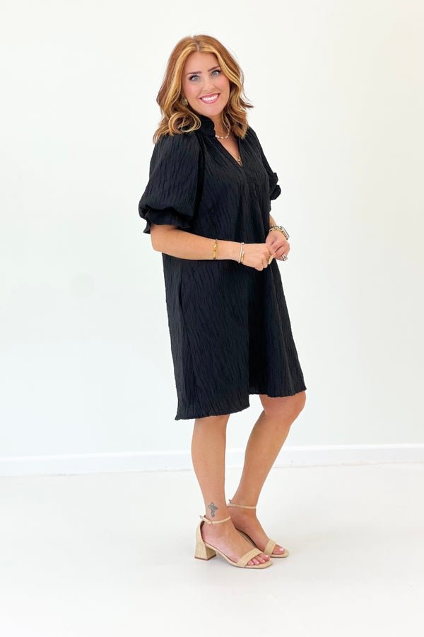 Short frilled sleeve dress in black with a flattering drape