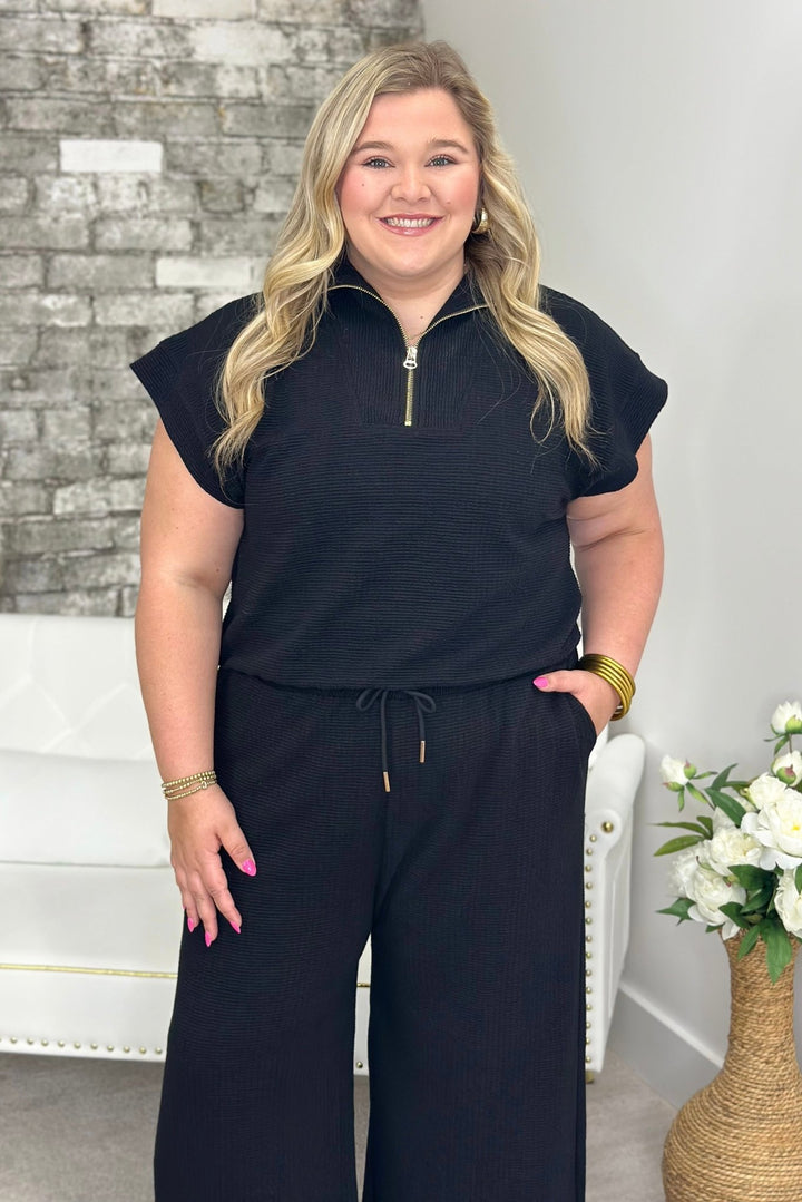 Black half zip mock neck top with matching bottoms