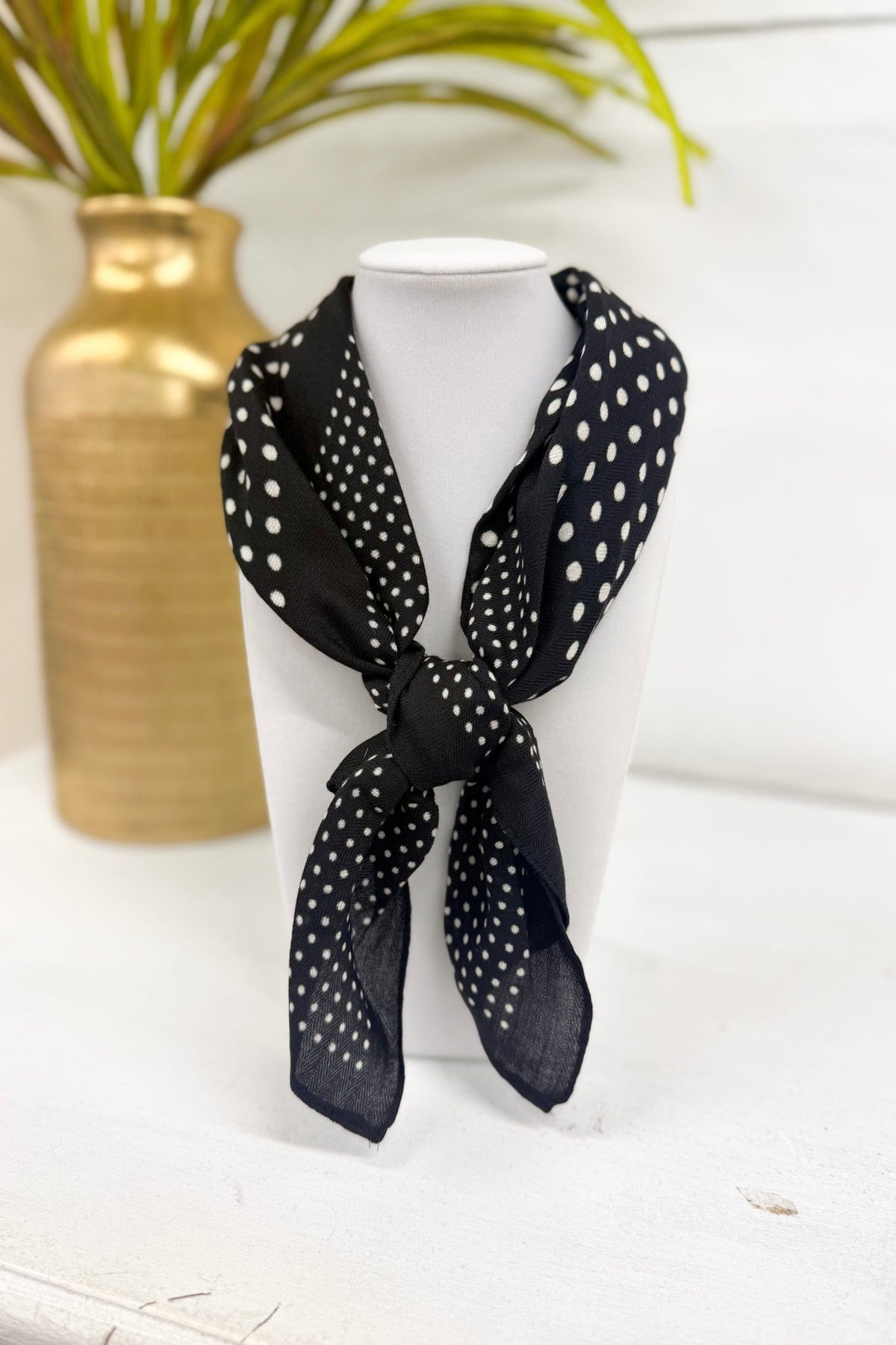 Black scarf with a rosette and polka dot print