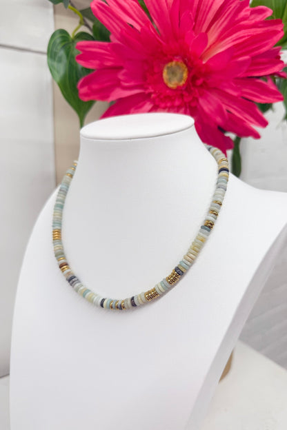 Strand of small blue beads on a necklace