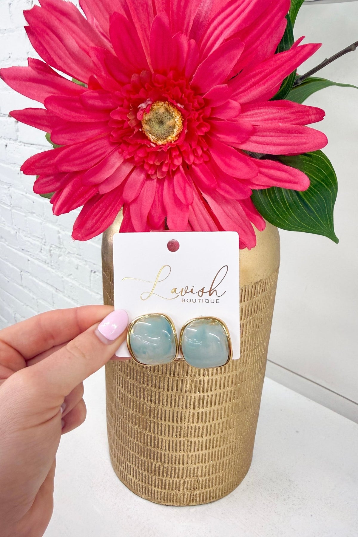 Star-shaped blue stone studs in gold settings