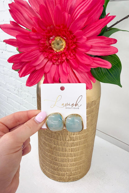 Star-shaped blue stone studs in gold settings