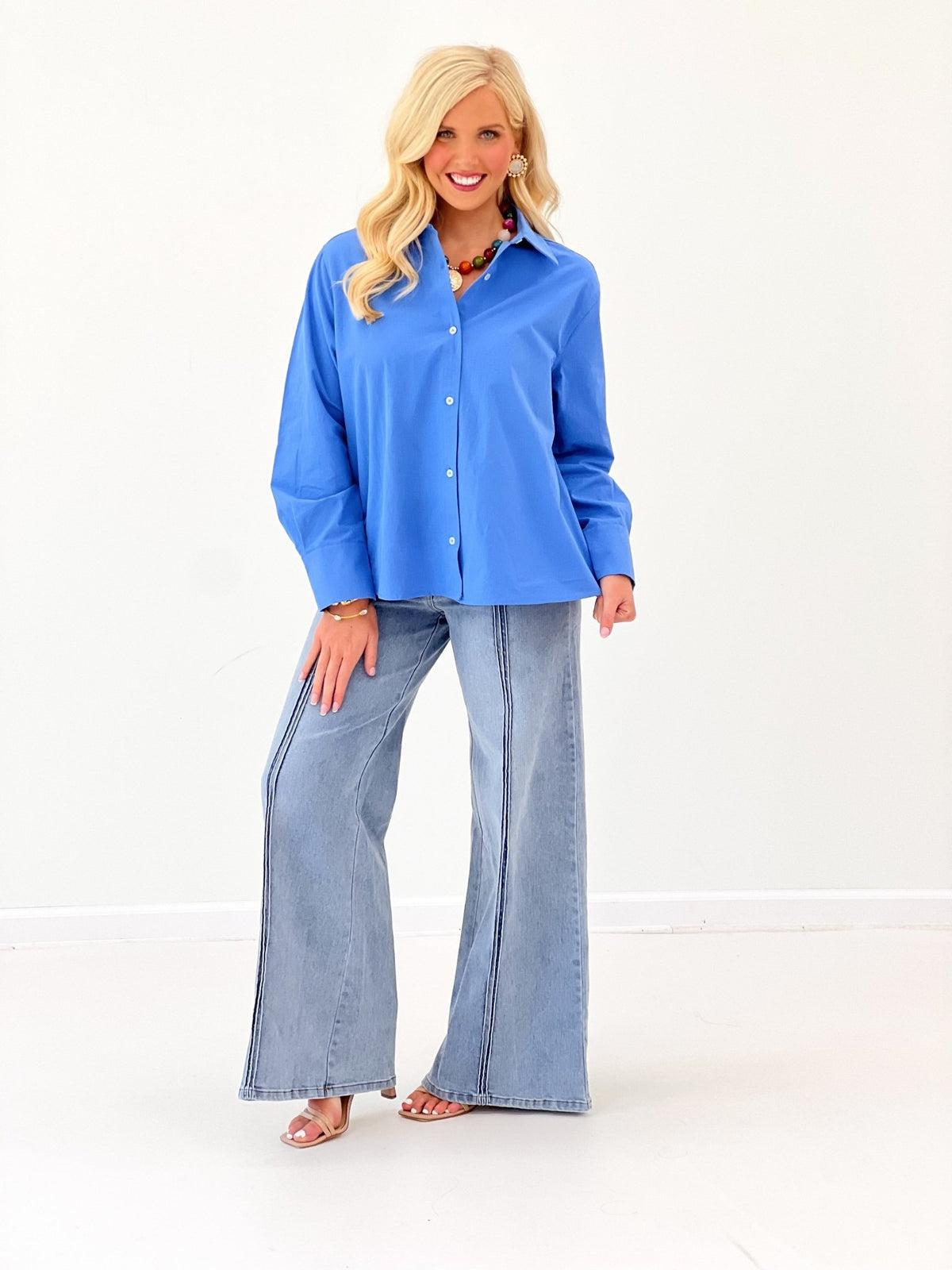 Women's blue long-sleeve collared button-down top with front buttons