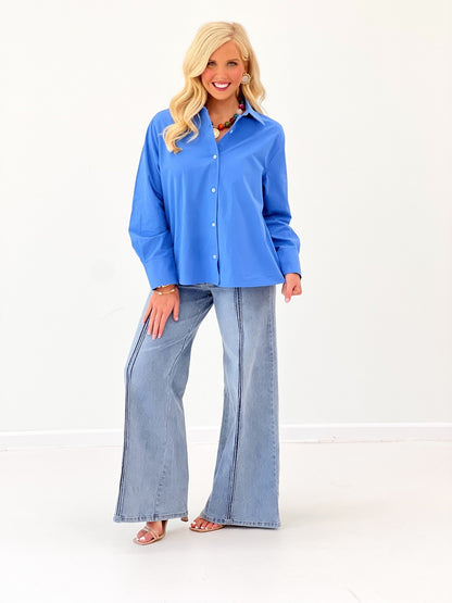 Women's blue long-sleeve collared button-down top with front buttons