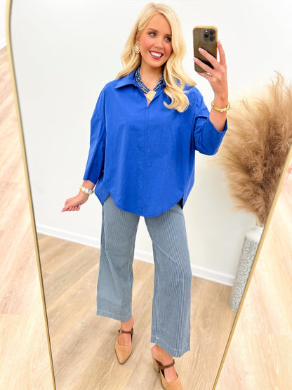 Blue top with a collar and soft front pleats