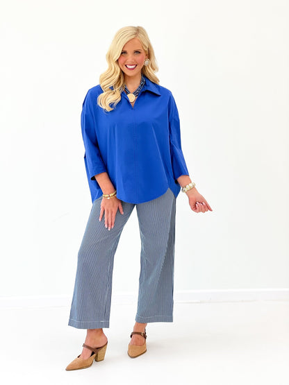 Pleated blue blouse with a pointed collar