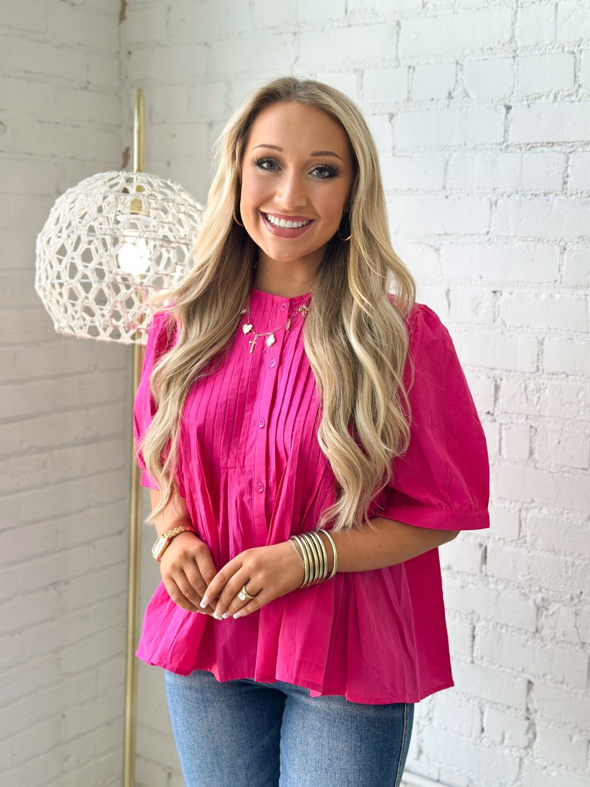 Pleated pink blouse with a full button front