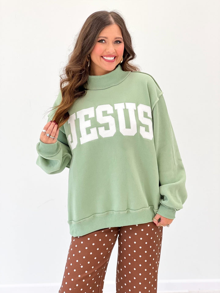 Sage sweatshirt with embroidered lettering and a mock neck