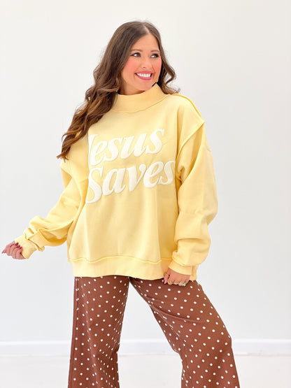 Yellow mock-neck sweatshirt with 'Jesus Saves' front graphic