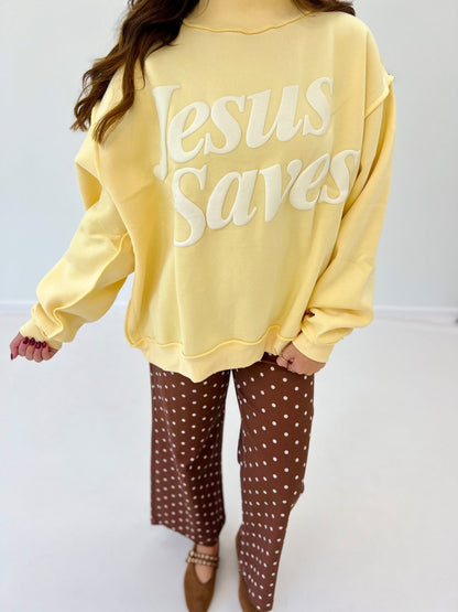 Yellow mock-neck sweatshirt with large 'Jesus Saves' back graphic