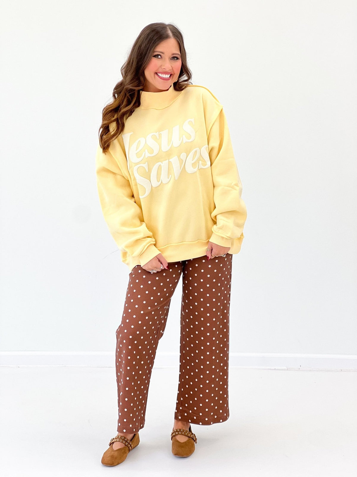 Yellow mock-neck sweatshirt with 'Jesus Saves' long-sleeve logo