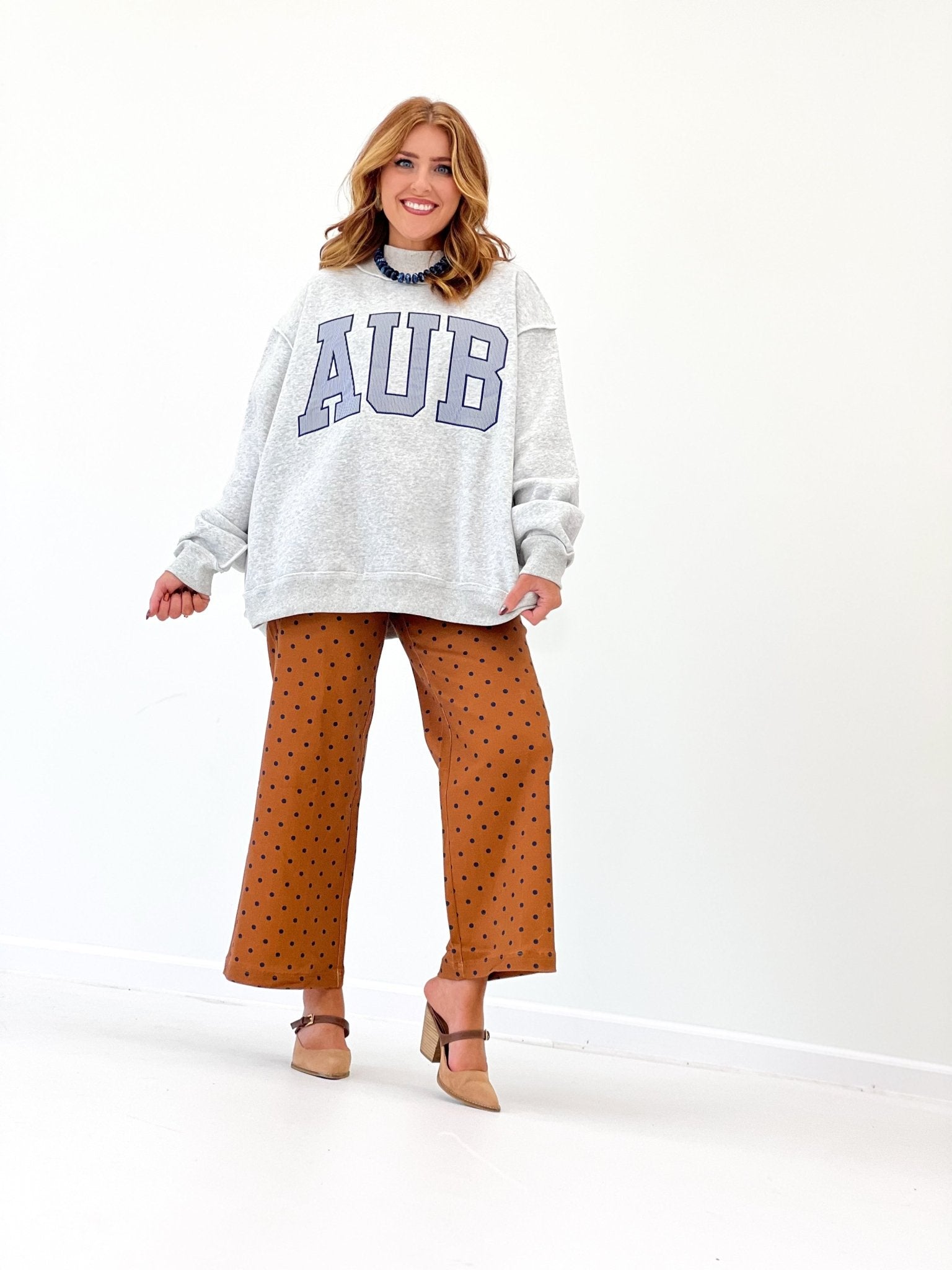 Grey mock neck sweatshirt with collegiate lettering