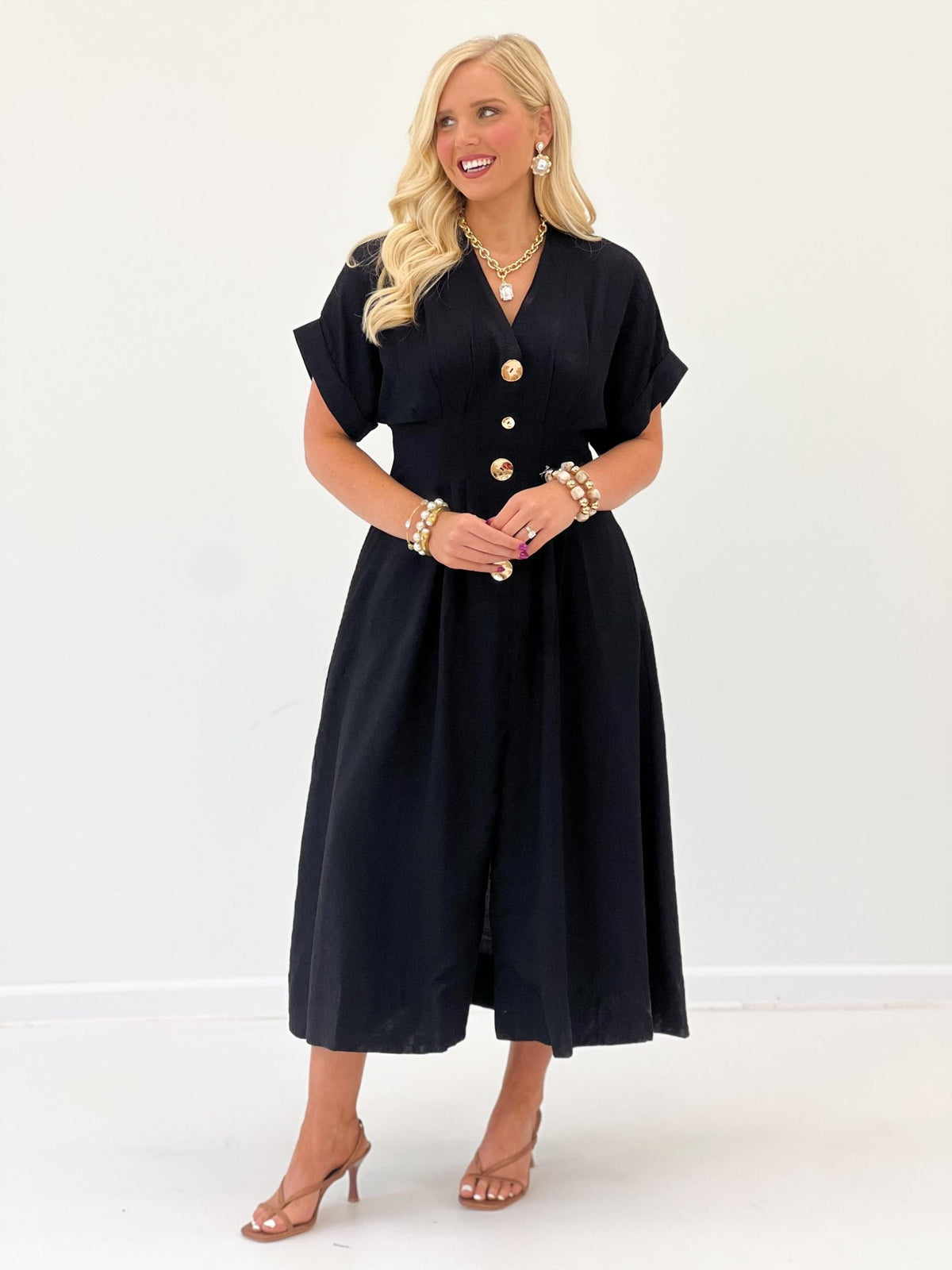 Full-length black dress with a buttoned bodice