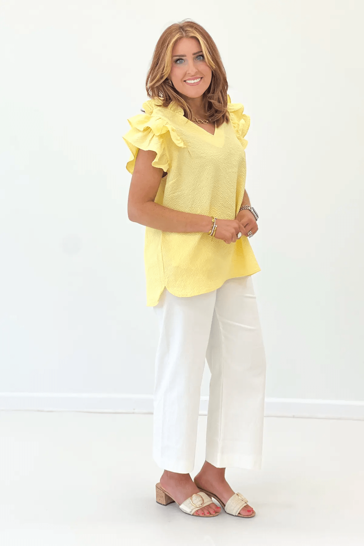 Model wearing the Ice Lemon V-Neck Ruffle Sleeve Top in a light yellow floral print with ruffle sleeves and V-neckline