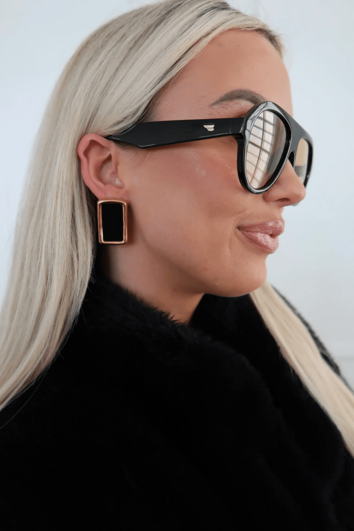 Black drop earrings on gold-tone posts