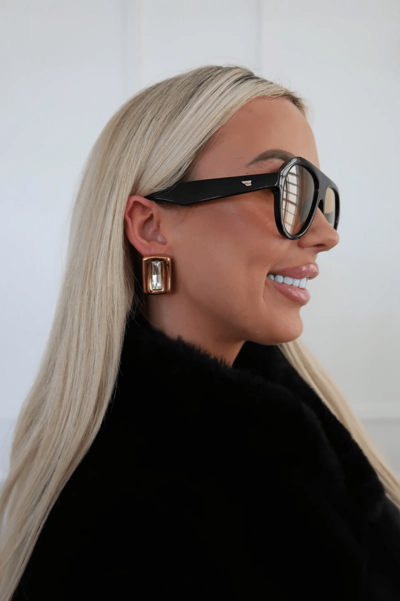 White drop earrings on gold-tone posts