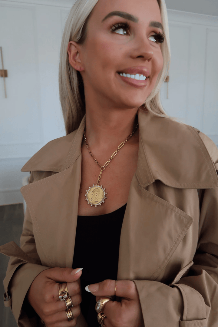 Gold lariat necklace with a coin pendant