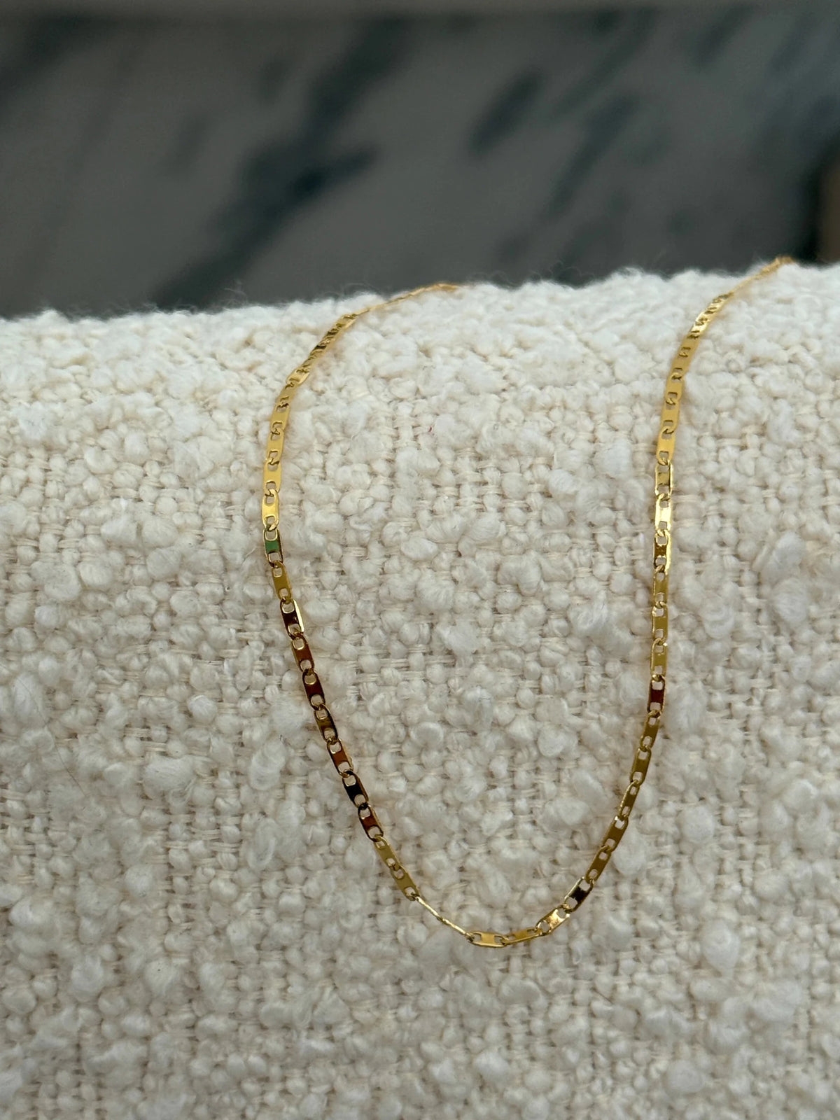 Fine gold chain necklace with a small charm
