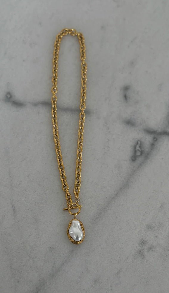 Gold chain necklace with a hanging pearl