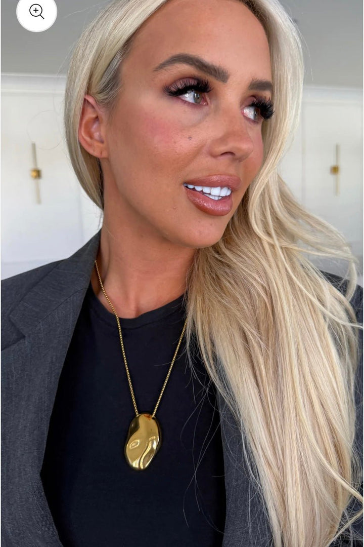 Gold chain necklace with a small pendant