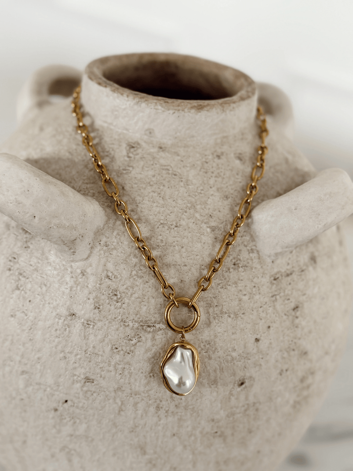 Gold chain necklace with a hanging pendant