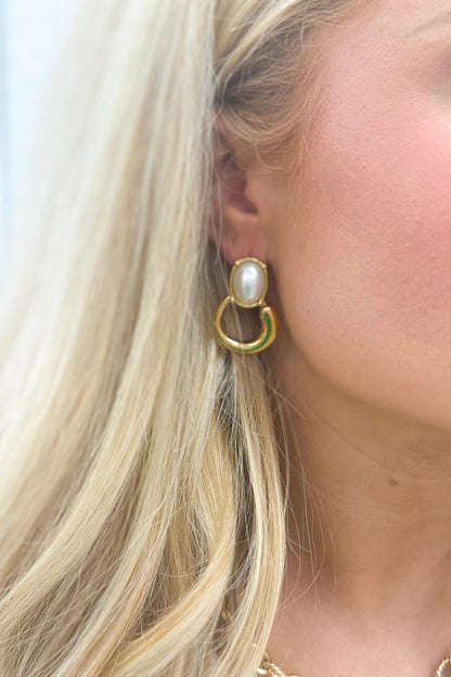 Pearl stud earrings with a ringed frame
