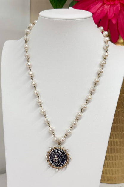 Round coin charm on a gold chain