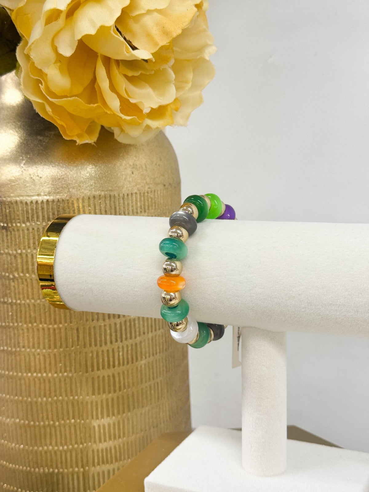 Colored beads strung with gold-tone balls