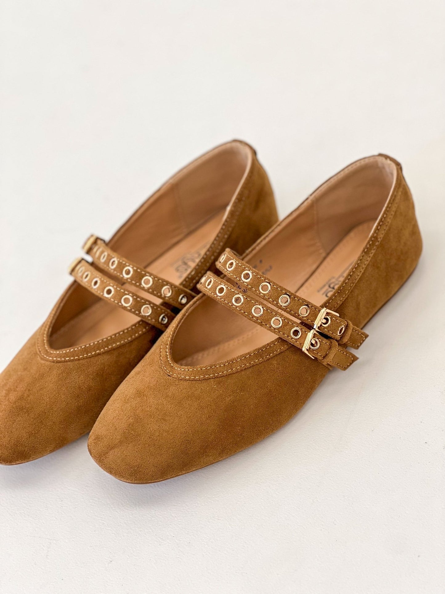 Camel faux suede Mary Jane flats, angled toe view, studded strap buckle