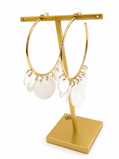 White stone earrings in a gold-tone setting