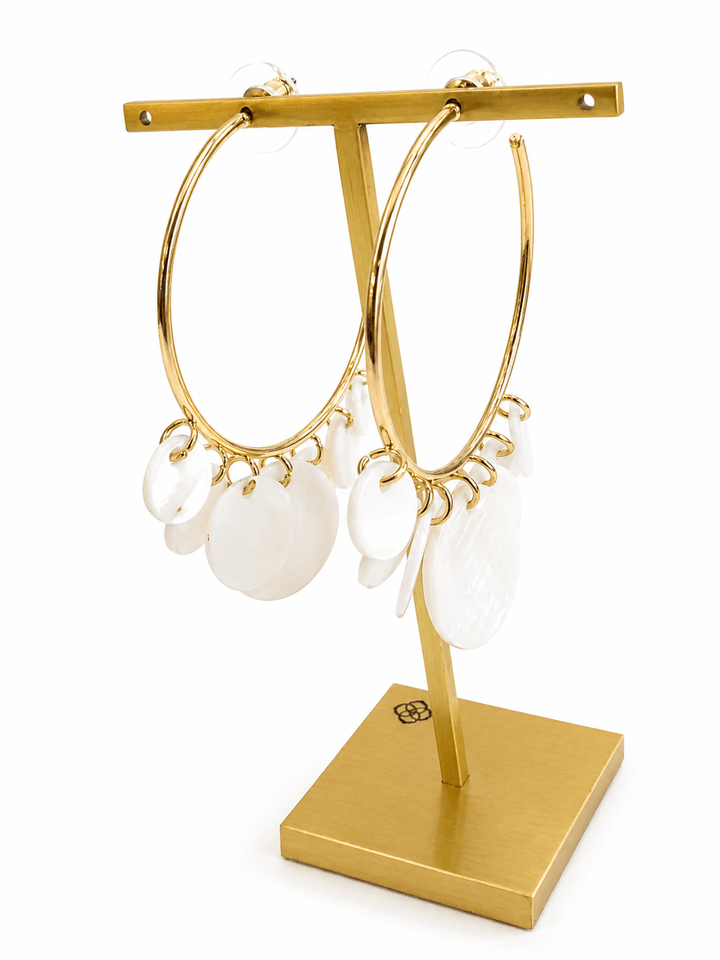 White stone earrings in a gold-tone setting