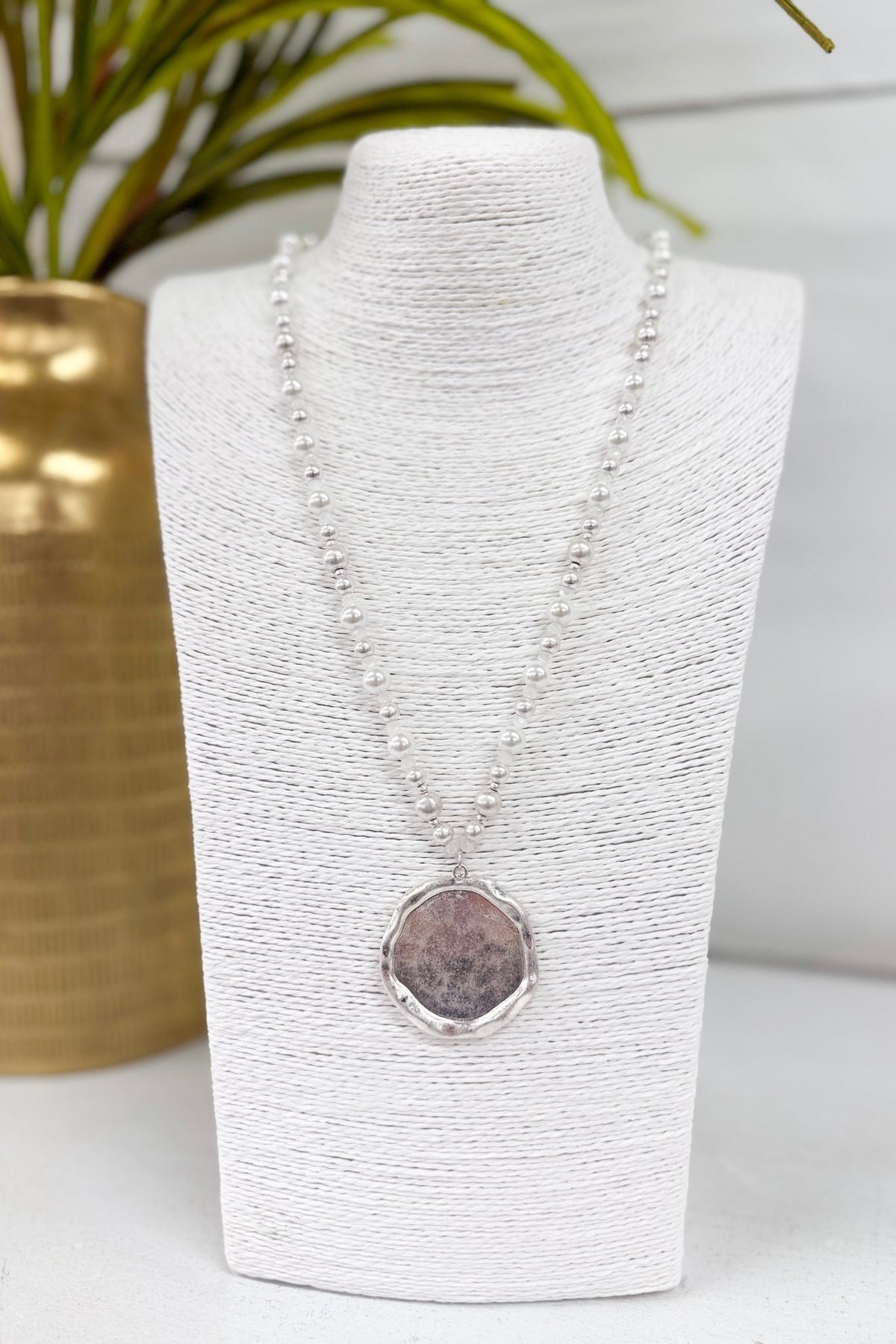 Cream pearl necklace with a silver round pendant
