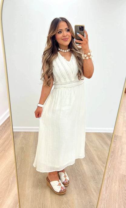 Cream and black textured midi dress with a fitted bodice and flared skirt