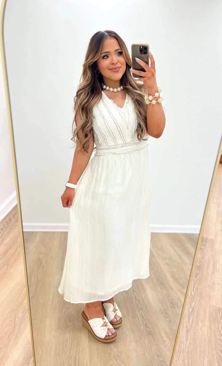 Cream and black textured midi dress with a fitted bodice and flared skirt