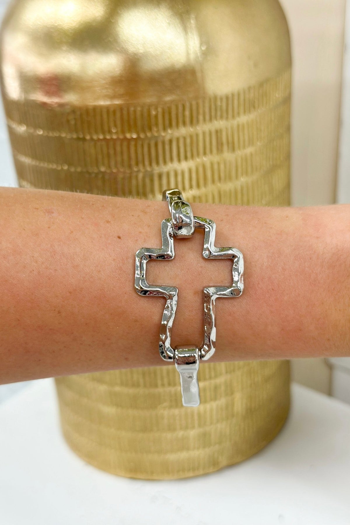 Bangle with a cut out cross at the center