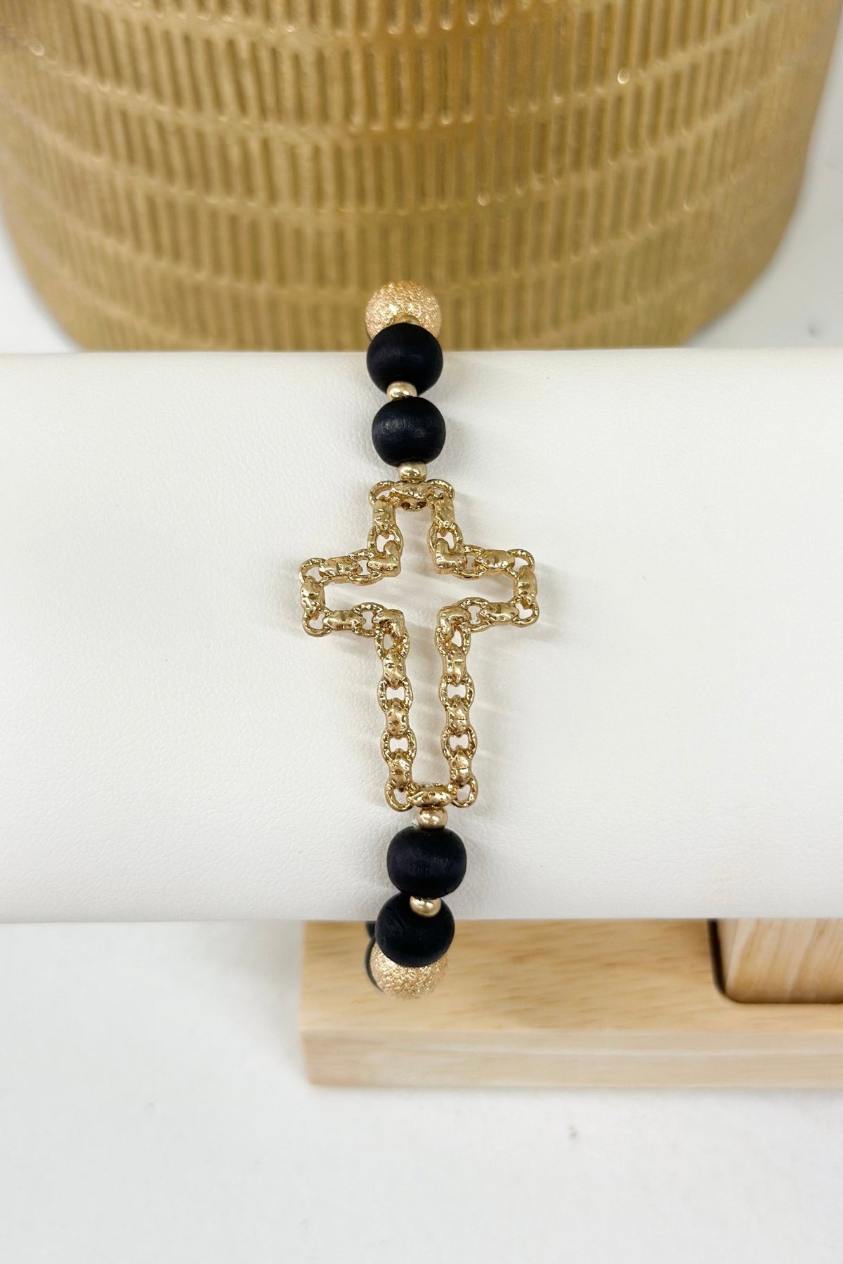 Wood bead bracelet with a cut out cross charm