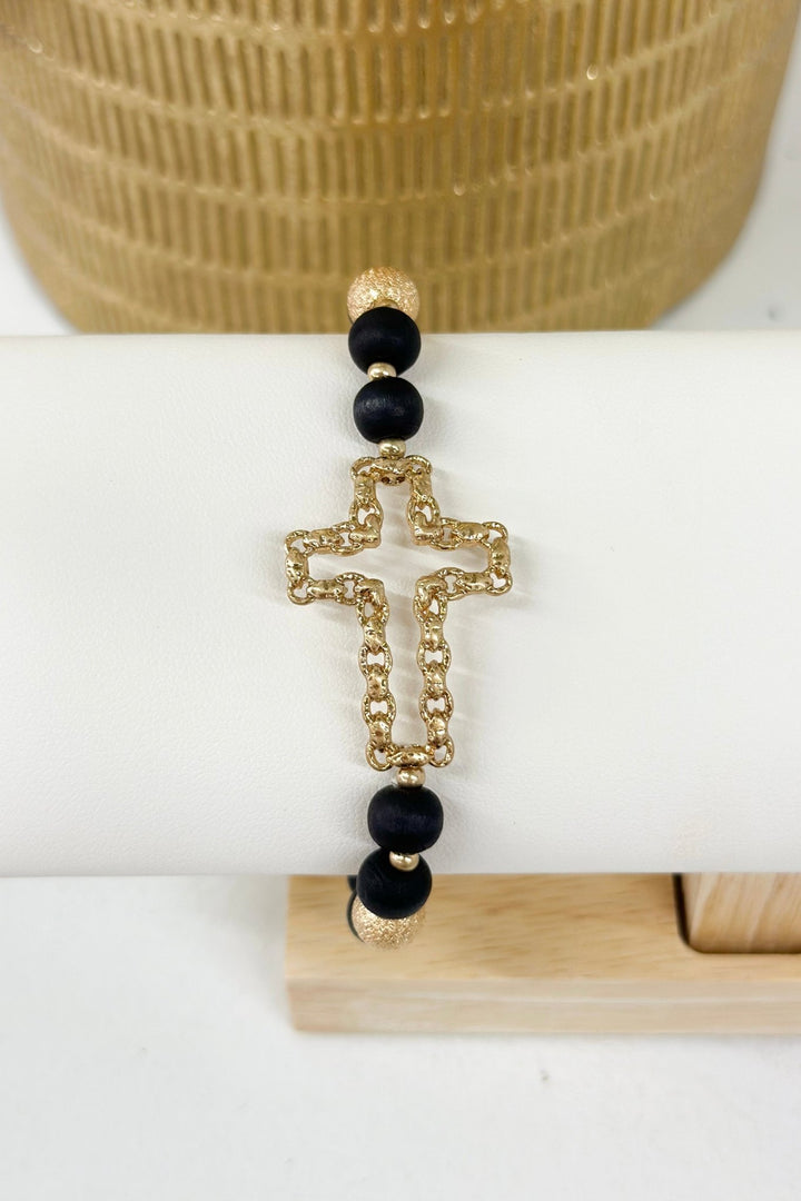 Wood bead bracelet with a cut out cross charm